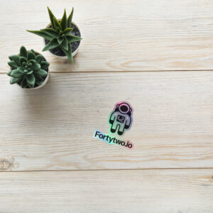 Astronaut sticker on wooden background